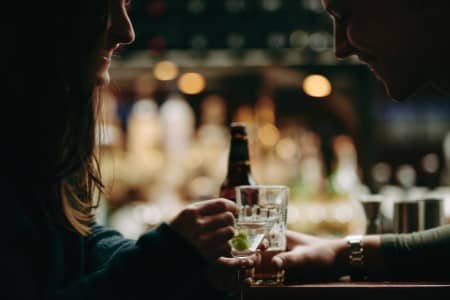 two people drinking at a bar