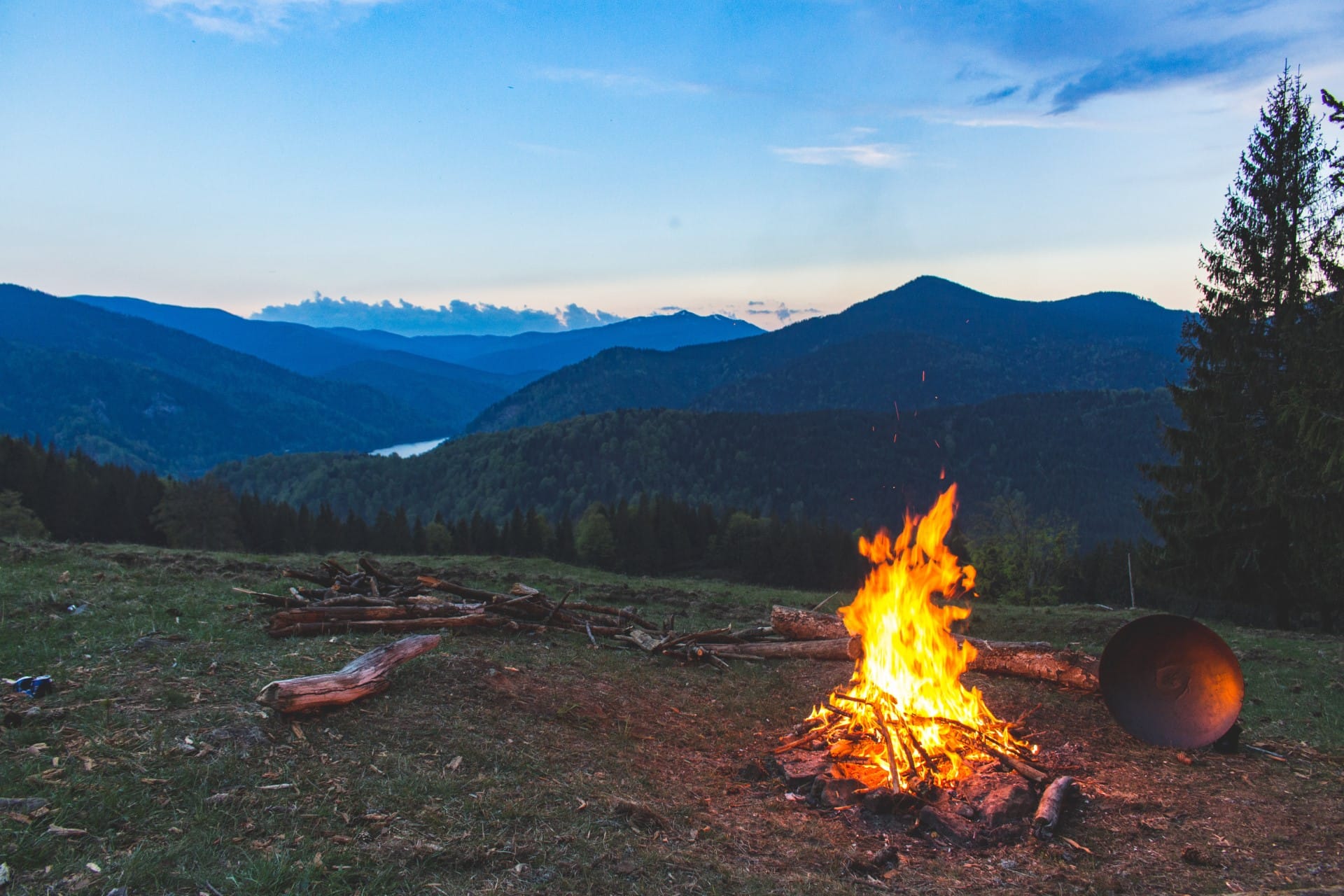 camp fire at sunset with mountain views