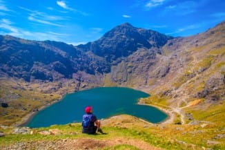hiking in Snowdonia - man enjoying the lake view